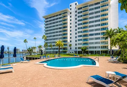 Boca Inlet Condo pool deck in Boca Raton with waterfront views, palm trees, lounge seating, and South Florida condo living.