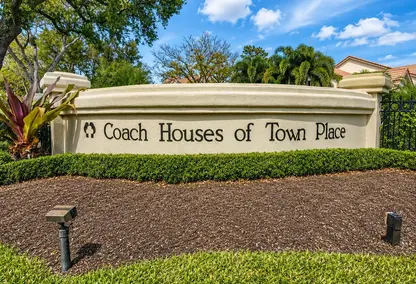 Coach Houses of Town Place neighborhood sign in Boca Raton with lush landscaping and luxury real estate appeal.