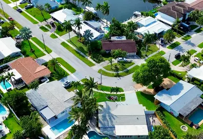 Aerial view of Lighthouse Point waterfront homes with private pools, canal-front lots, boat docks, and South Florida coastal real estate.