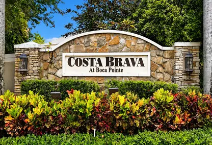 Costa Brava at Boca Pointe neighborhood sign in Boca Raton with lush landscaping and luxury South Florida real estate appeal.