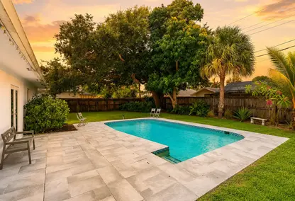 Country Club Village Boca Raton pool home with private backyard, tropical landscaping, and luxury outdoor living.