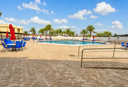 Crosley West Palm Beach community pool with lounge seating, tropical palms, and resort-style South Florida amenities.