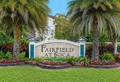 Fairfield at Boca neighborhood entrance in Boca Raton with lush palm trees, landscaped sign, and desirable South Florida real estate setting.