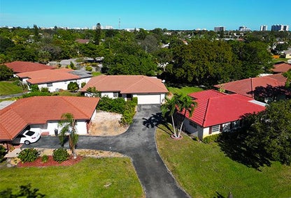 Drone image of a set of homes with red roofs in Knob Hill, Boca Raton, Florida.