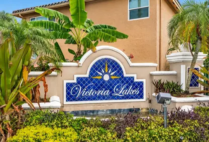 Victoria Lakes neighborhood entrance in Pembroke Pines, South Florida with tropical landscaping and real estate community appeal.