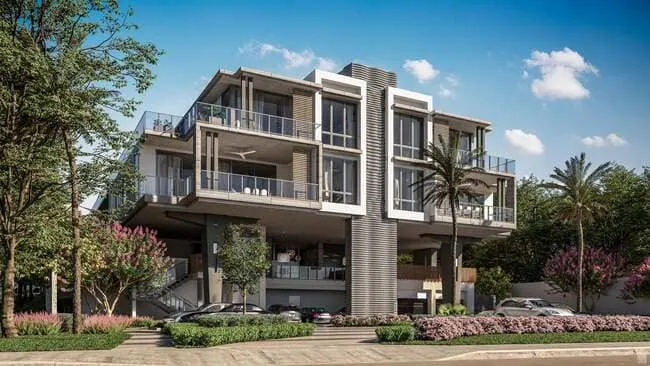 1625 Ocean beachfront condo at dusk with glowing interiors, palm trees, and loungers along the sandy shoreline.