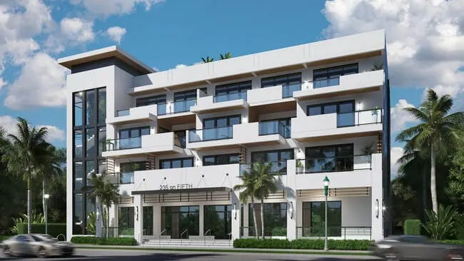 Modern four-story condominium with clean white facade, glass balconies, and palm trees lining the street in front.