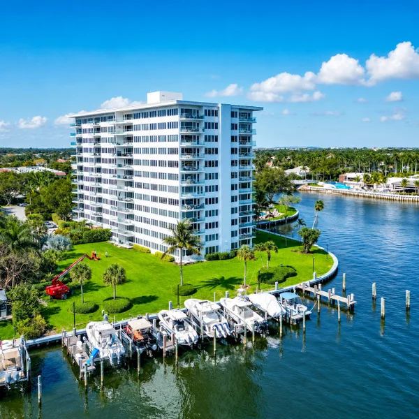 Aerial view of Boca Inlet Condo in Boca Raton with Intracoastal frontage, boat docks, and waterfront luxury real estate.