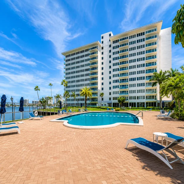Boca Inlet Condo pool deck in Boca Raton with waterfront views, palm trees, lounge seating, and South Florida condo living.