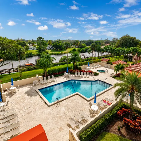 Bramalea Boca Raton real estate community pool with canal views, resort-style amenities, tropical landscaping, and waterfront lifestyle.
