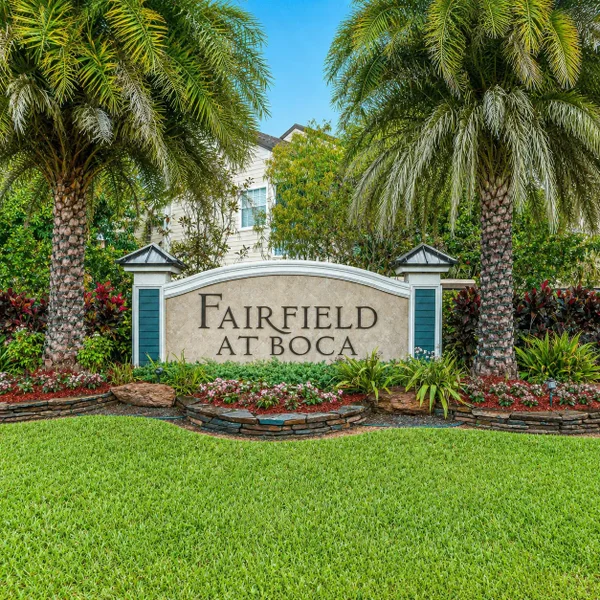 Fairfield at Boca neighborhood entrance in Boca Raton with tropical landscaping, palm trees, and South Florida real estate community appeal.