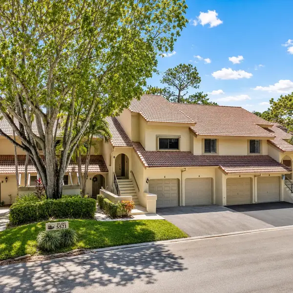 Coach Houses of Town Place Boca Raton townhomes with garages, tropical landscaping, and upscale South Florida living.