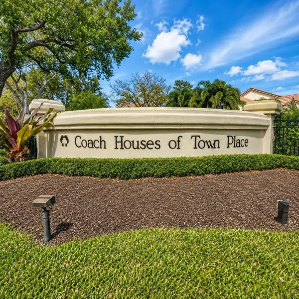 Coach Houses of Town Place neighborhood sign in Boca Raton with lush landscaping and luxury real estate appeal.