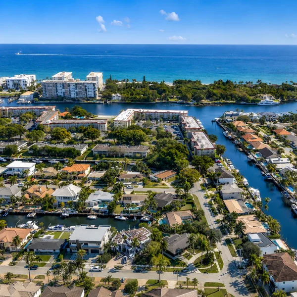 Aerial view of luxury waterfront homes in Lighthouse Point, Florida, featuring deepwater canals, private docks, ocean access, Coral Key Villas real estate.