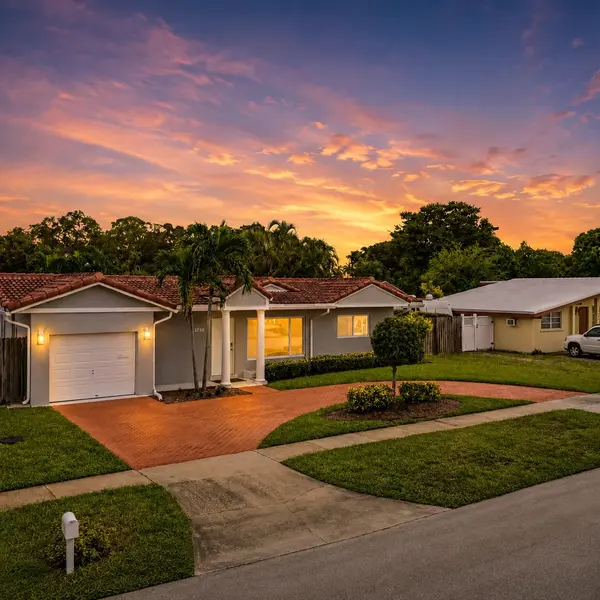 Country Club Village Boca Raton luxury home at sunset with warm exterior lighting and refined South Florida living.