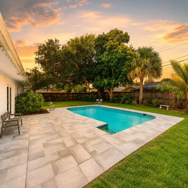 Country Club Village Boca Raton pool home with private backyard, tropical landscaping, and luxury outdoor living.