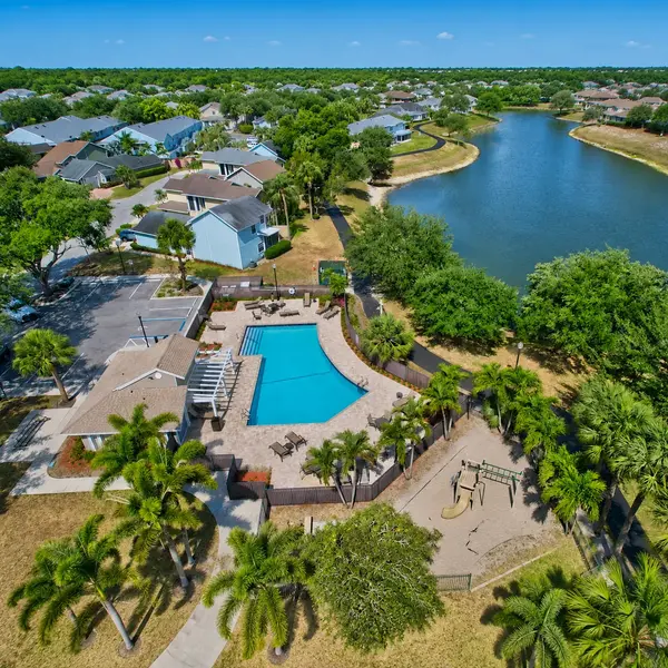 Fairfield at Boca Boca Raton community amenities with resort-style pool, lake views, playground, and tropical South Florida real estate appeal.