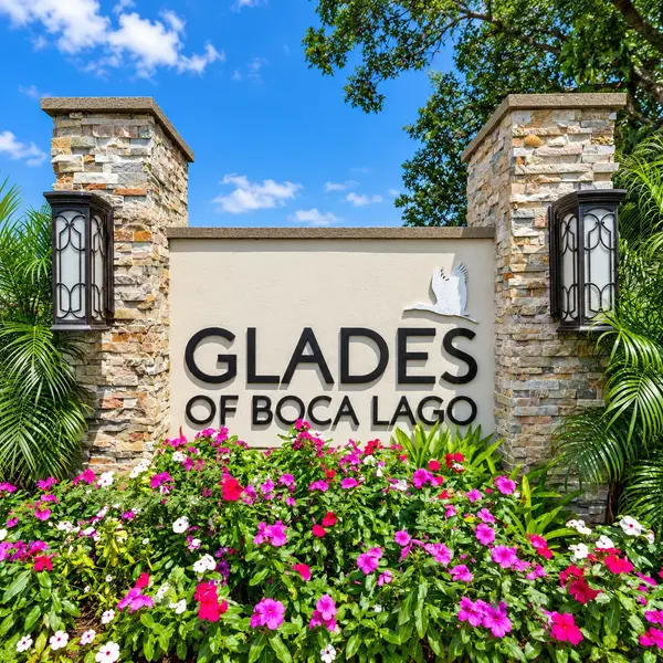 Glades of Boca Lago 55+ community entrance in Boca Raton with tropical landscaping and luxury South Florida appeal.