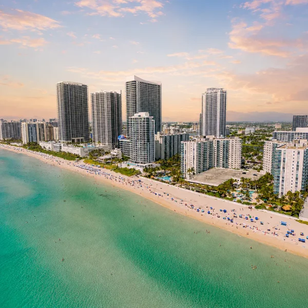 Hallandale Beach luxury oceanfront condos in South Florida with turquoise water, sandy beach, and high-rise Luxury real estate.