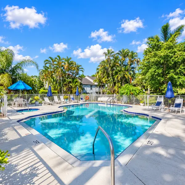 Heatherwood condos Boca Raton resort-style pool with palm trees, lounge seating, and sunny South Florida amenities.