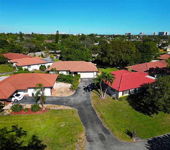 Drone image of a set of homes with red roofs in Knob Hill, Boca Raton, Florida.