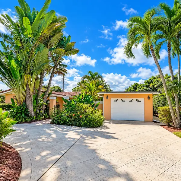 Lake Wyman Shores Boca Raton single-family home with palm trees, bright driveway, and tropical East Boca living.