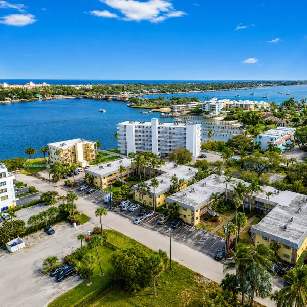 Lantana Florida luxury real estate aerial with waterfront condos, tropical landscaping, marina views, and South Florida Intracoastal lifestyle.