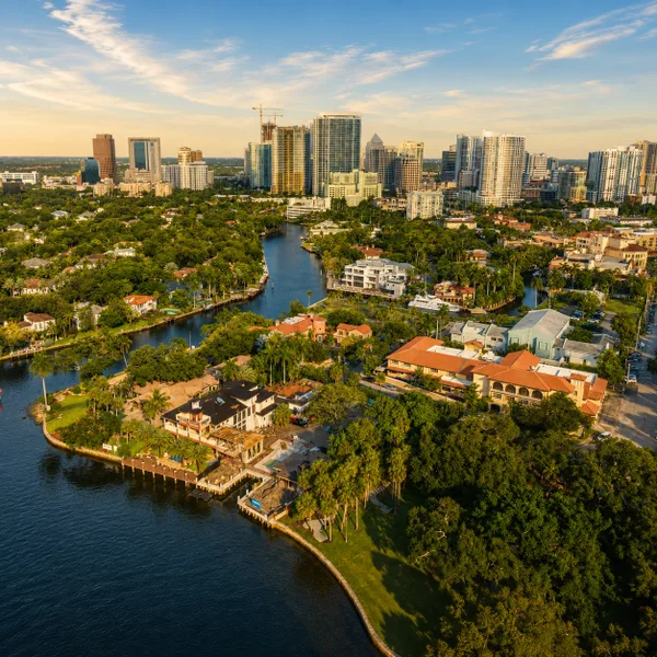 Lauderdale Lakes condo community aerial with tropical landscaping, city skyline views, and South Florida real estate.
