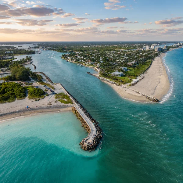 Loxahatchee Florida luxury real estate lifestyle with serene sunset water views, lush greenery, nature preserves, and upscale rural living.