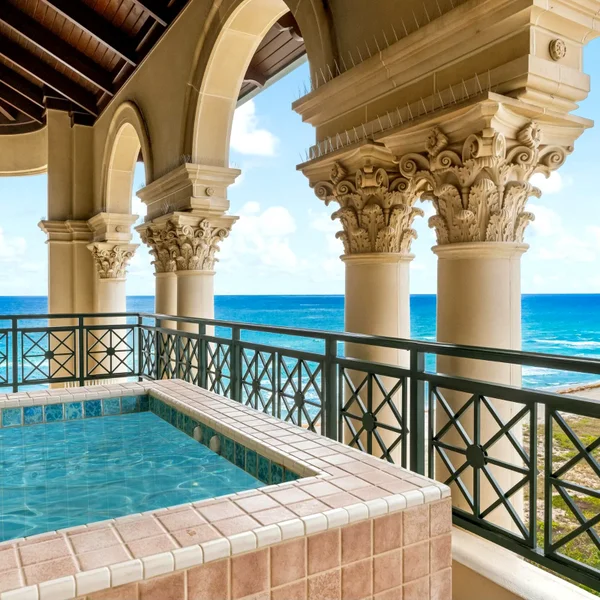 Luxuria Boca Raton luxury condo balcony with private plunge pool, ocean views, arched columns, and beachfront real estate appeal.