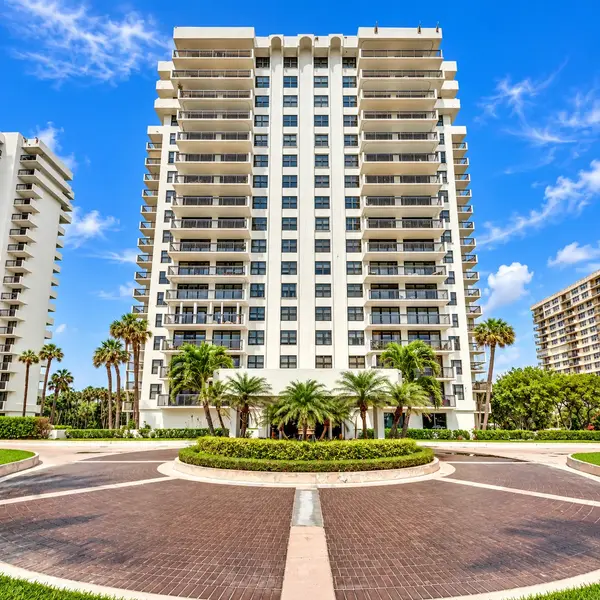 La Fontana Boca Raton condo tower with palm-lined entrance, balconies, and luxury South Florida waterfront appeal.