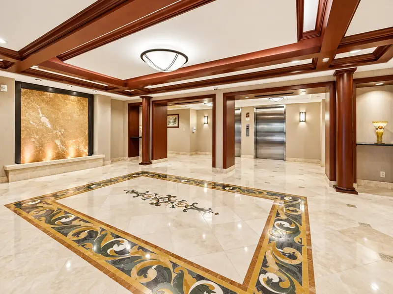 La Fontana condominiums Boca Raton lobby with marble floors, wood details, and upscale residential interiors.