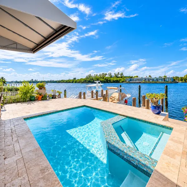Lake Wyman Estates Boca Raton pool overlooking the water with private dock and luxury coastal views.