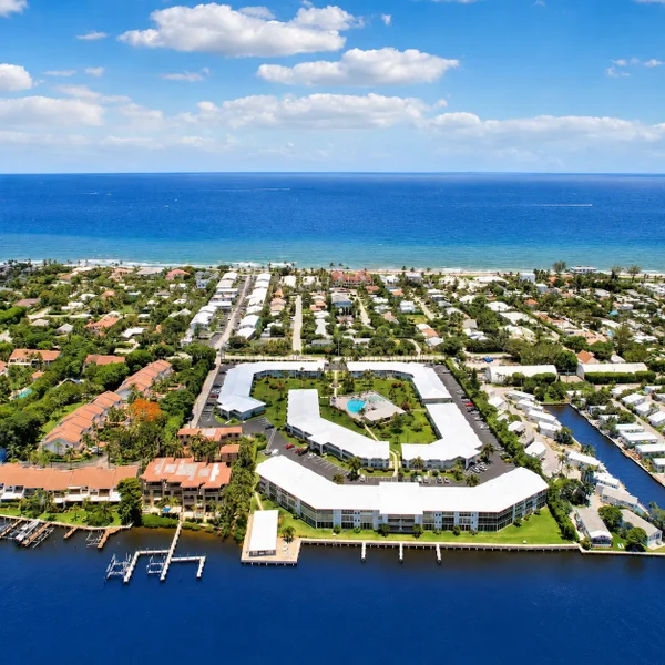 Ocean Ridge Florida luxury real estate aerial with waterfront homes, beachside condos, marina docks, and Atlantic Ocean views.