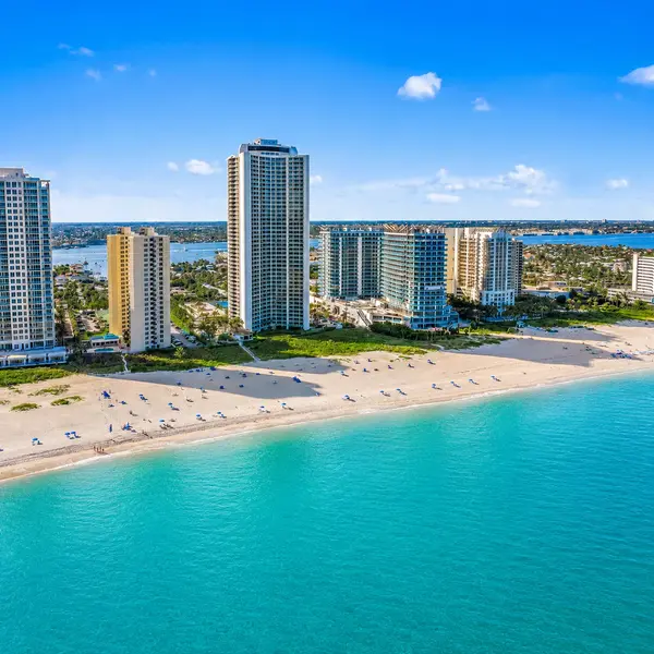 Riviera Beach South Florida luxury condos with oceanfront high-rises, sandy beach, turquoise water, and coastal real estate views.