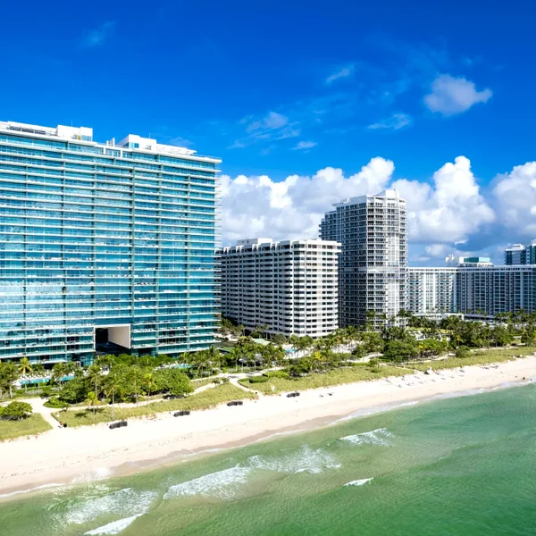 Sunny Isles Beach luxury real estate skyline with oceanfront condos, sandy beach, and turquoise Atlantic views in South Florida.