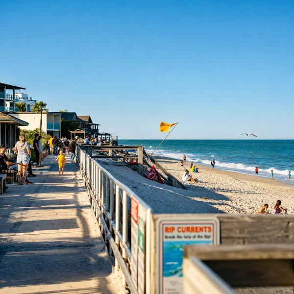 Vero Beach City South Florida beach scene with boardwalk, sandy shoreline, ocean views, and Luxury real estate lifestyle appeal.