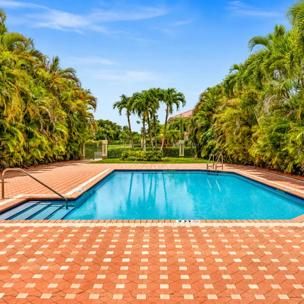 Victoria Lakes Pembroke Pines pool area with palm trees, brick patio, and South Florida residential real estate amenities.