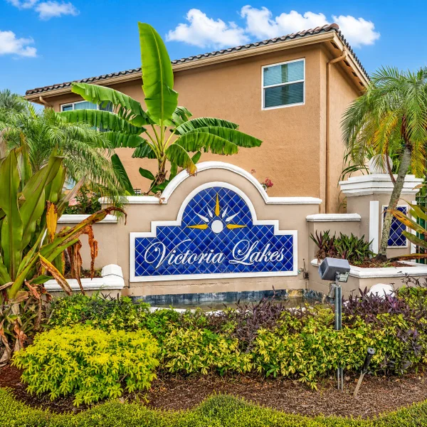 Victoria Lakes neighborhood entrance in Pembroke Pines, South Florida with tropical landscaping and real estate community appeal.
