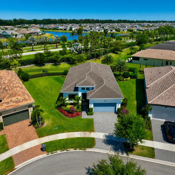 Westlake FL luxury property with modern single-family home, lush landscaping, lake views, and upscale South Florida residential living.