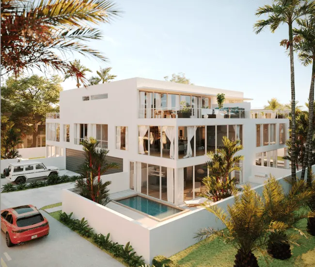 Modern three-story white building at Asea Delray Beach with large glass windows, tropical landscaping, and a private pool.