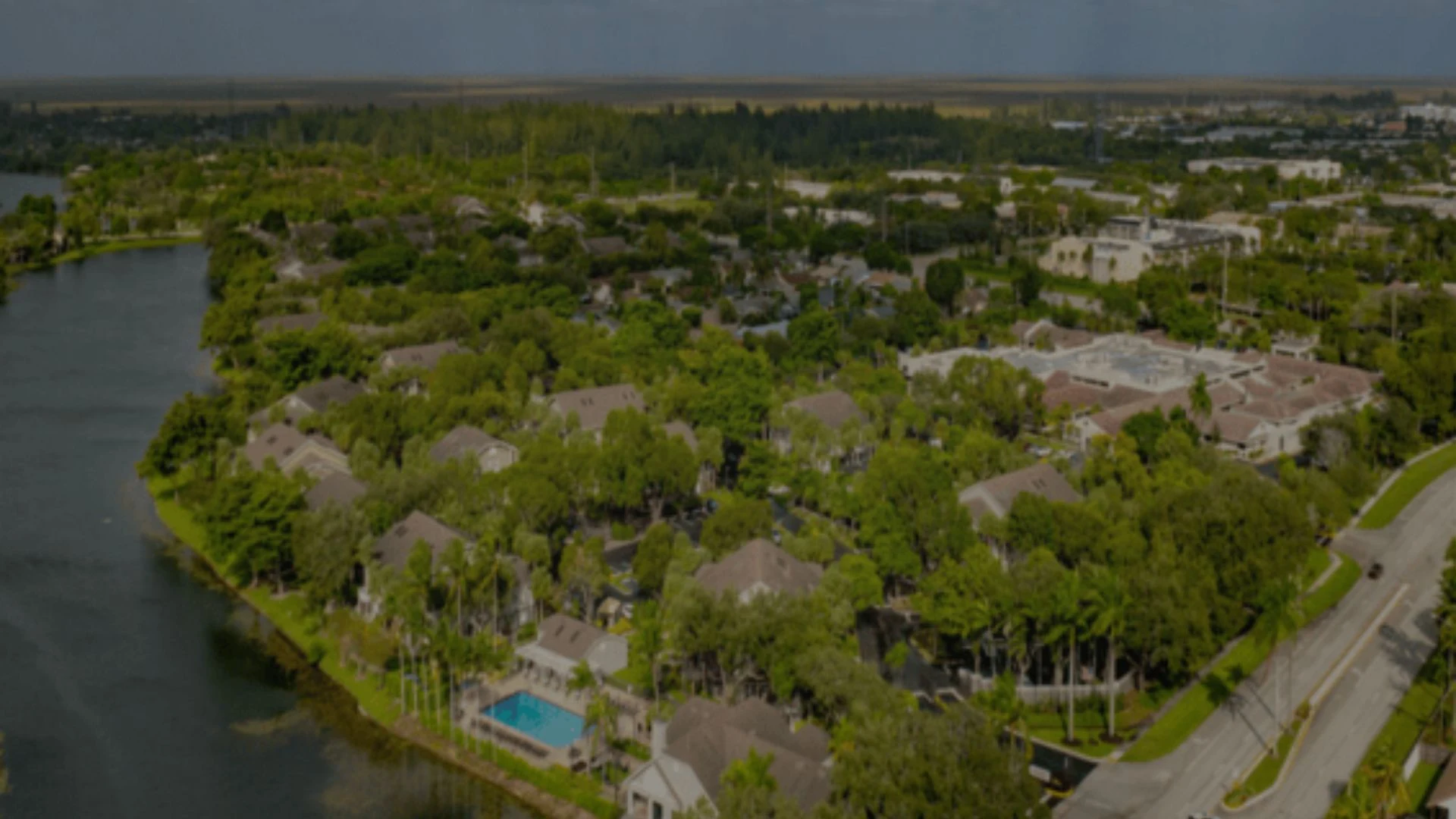 Aerial views of ranch-style homes among trees in Sunrise, FL.