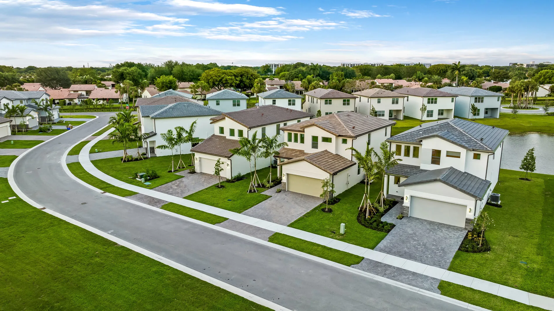 Aerial view of modern single-family homes at Nuvo Boca, a rental community in Boca Raton with green landscaping and wide streets.
